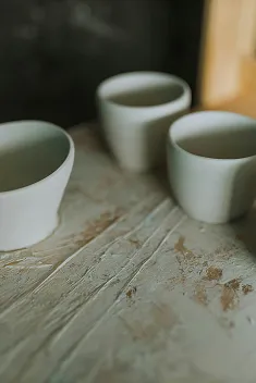 Three empty white cups.