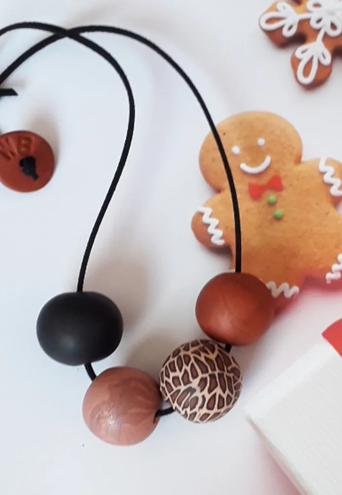 Brown necklace with tiger motifs.