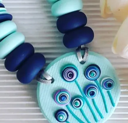 Necklace white blue flowers on it.