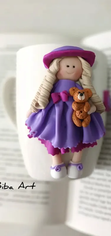 White cup with girl dressed in purple dress.