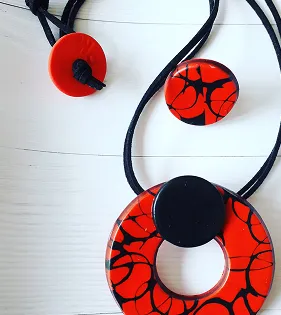 Red necklace with black stripes.